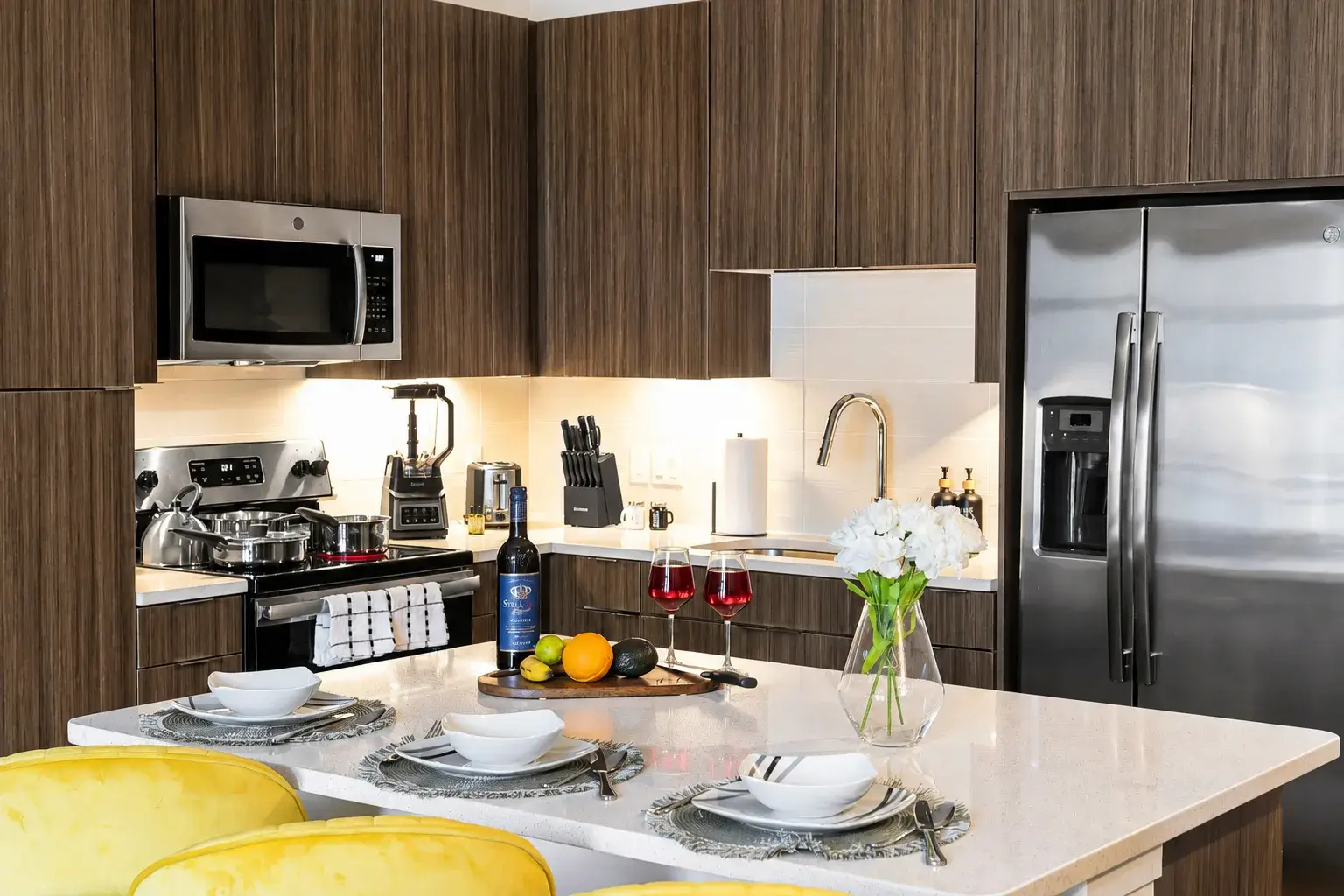 Stylish modern kitchen with island dining and stainless steel appliances
