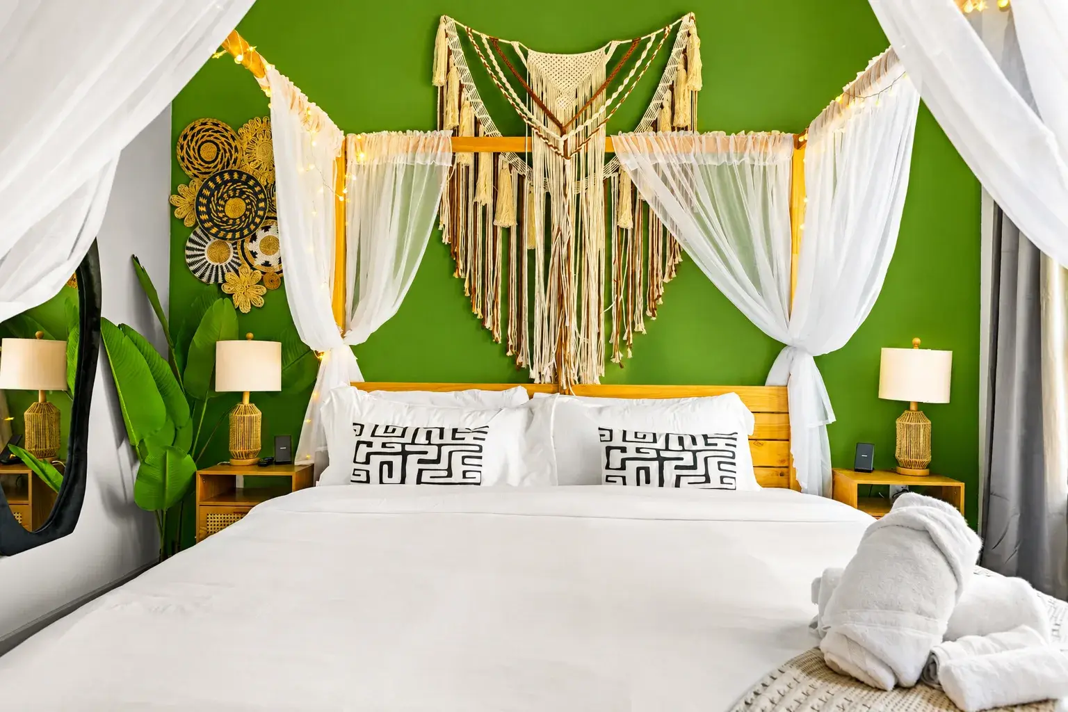Boho king suite with canopy bed, tropical accents, and cozy lighting