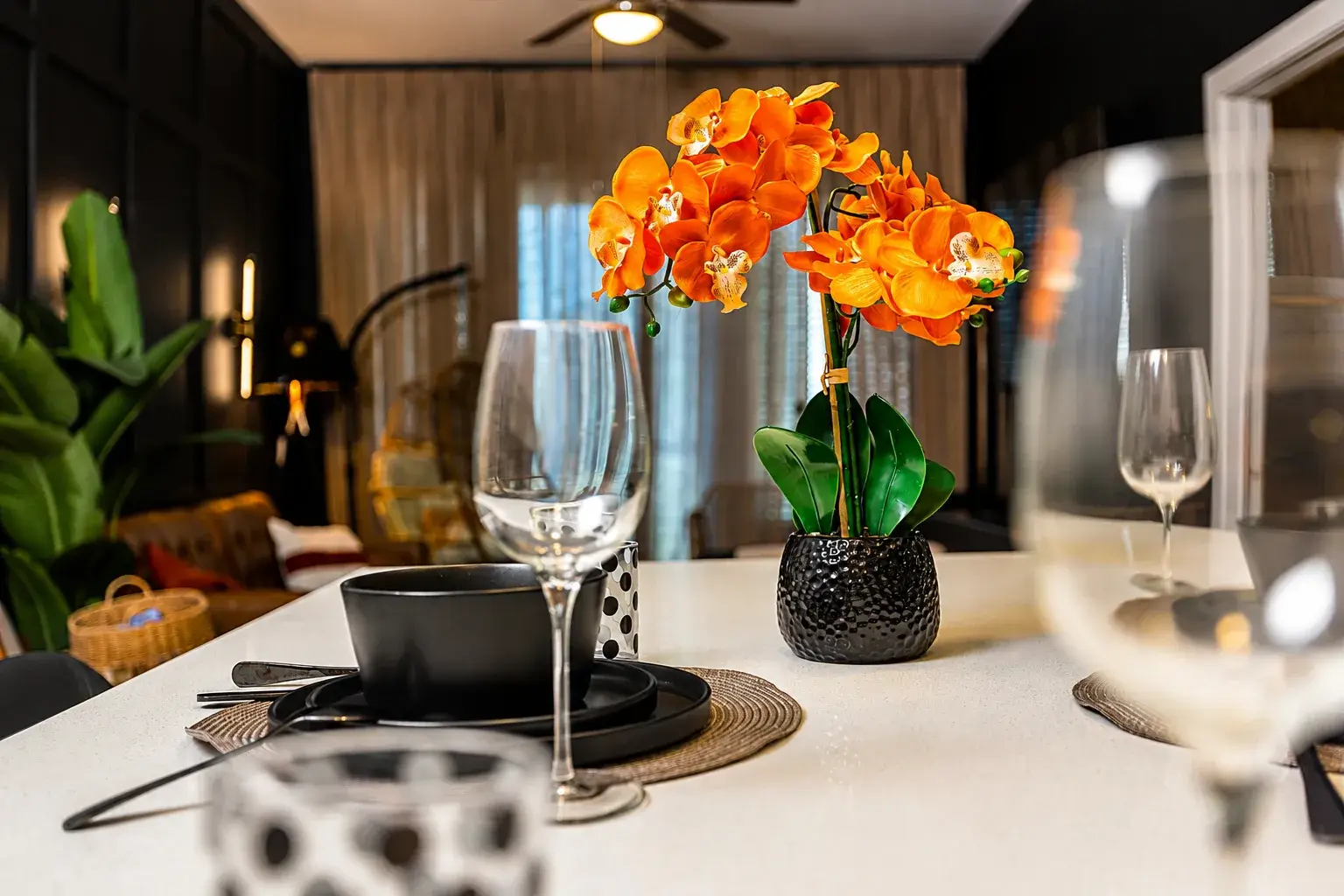 Elegant dining island with chic place settings and a vibrant orchid centerpiece