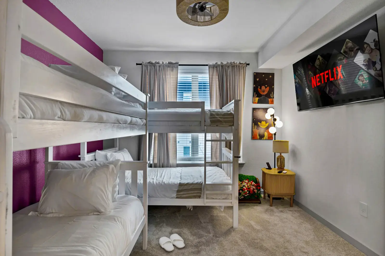 Bunk room with four beds and a TV