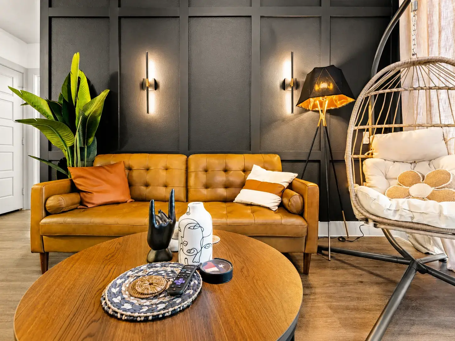 Chic lounge with leather sofa, egg chair, and bold designer touches