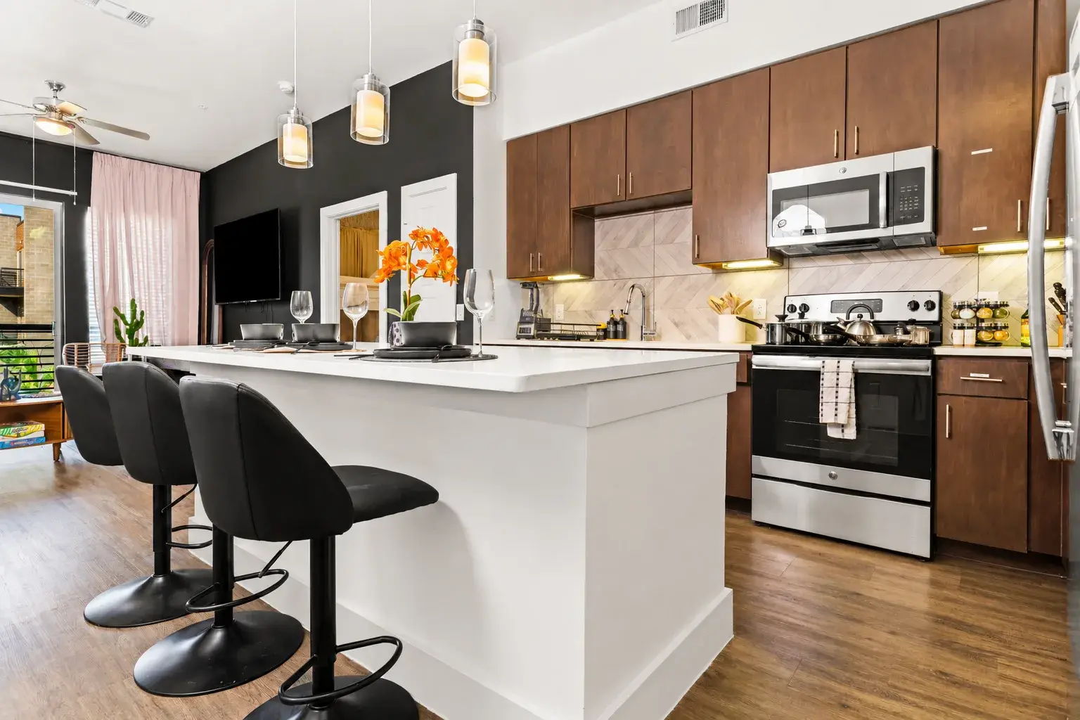 Modern open kitchen with island seating, stainless appliances, and bright style