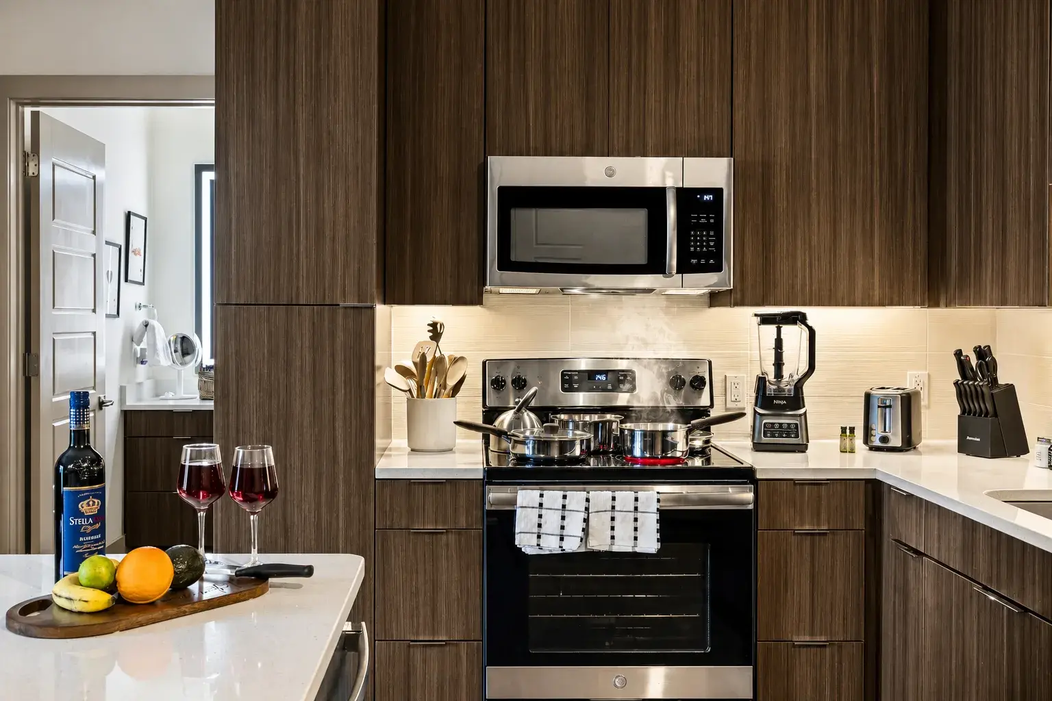 Modern chef’s kitchen with wine setup, sleek finishes, and bright lighting