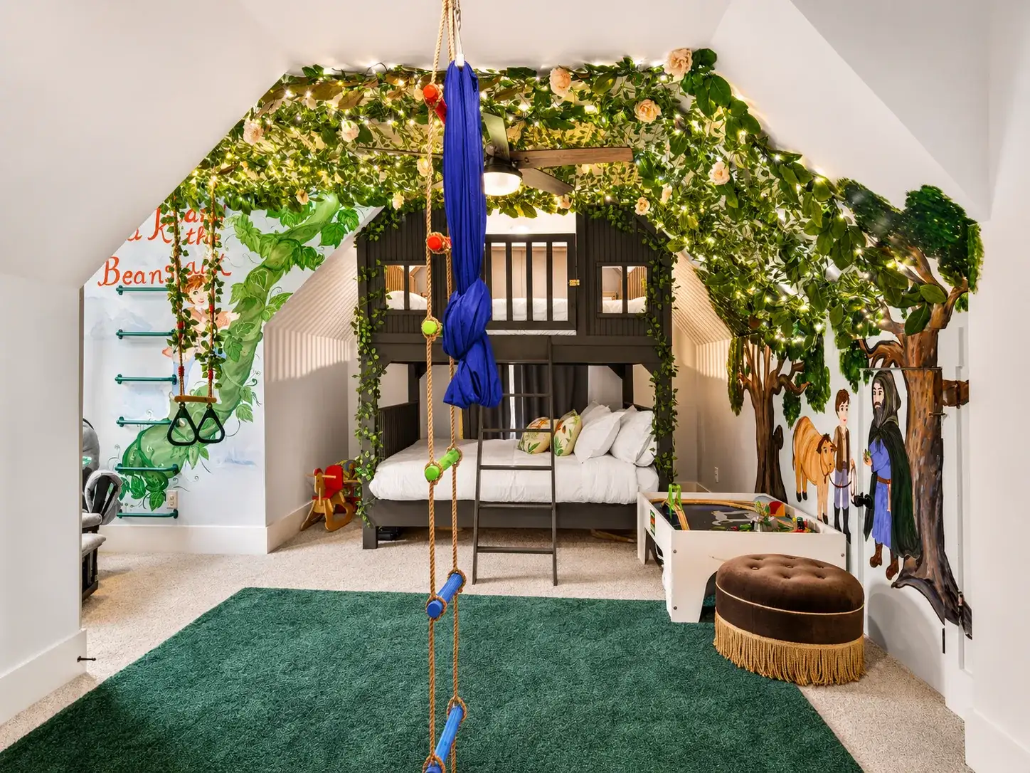 Hand painted adventure room with treehouse bunk beds, fairy lights and a beanstalk mural