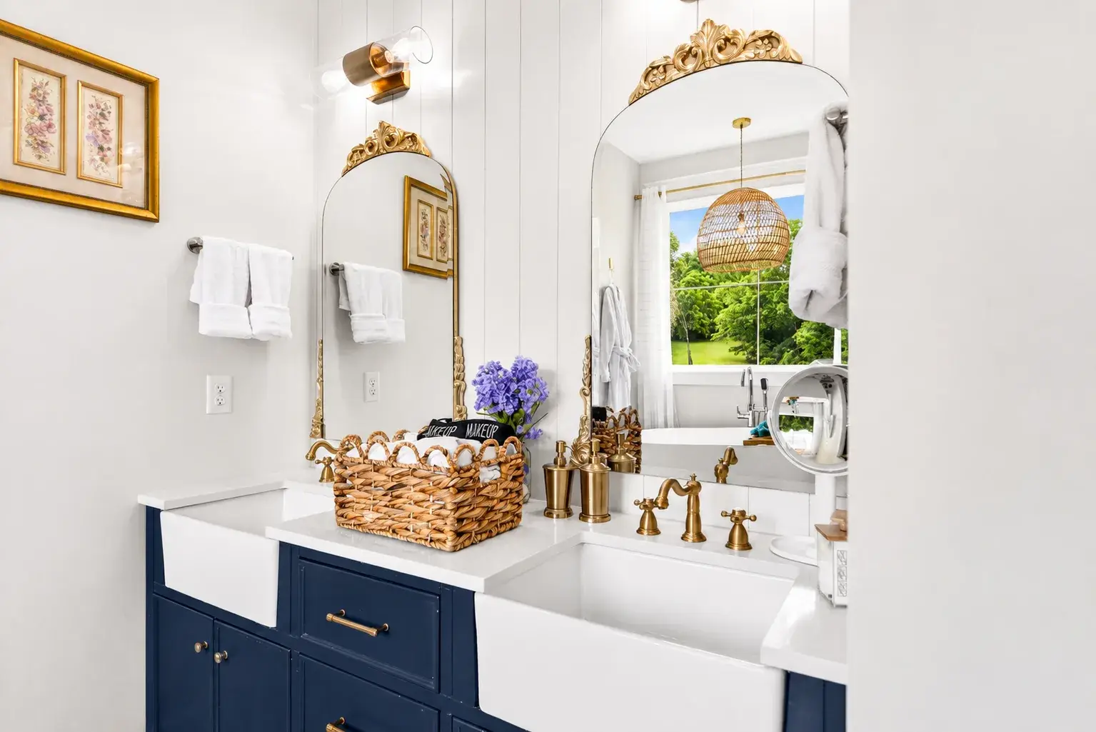 Elegant double vanity with brass accents and bright garden views