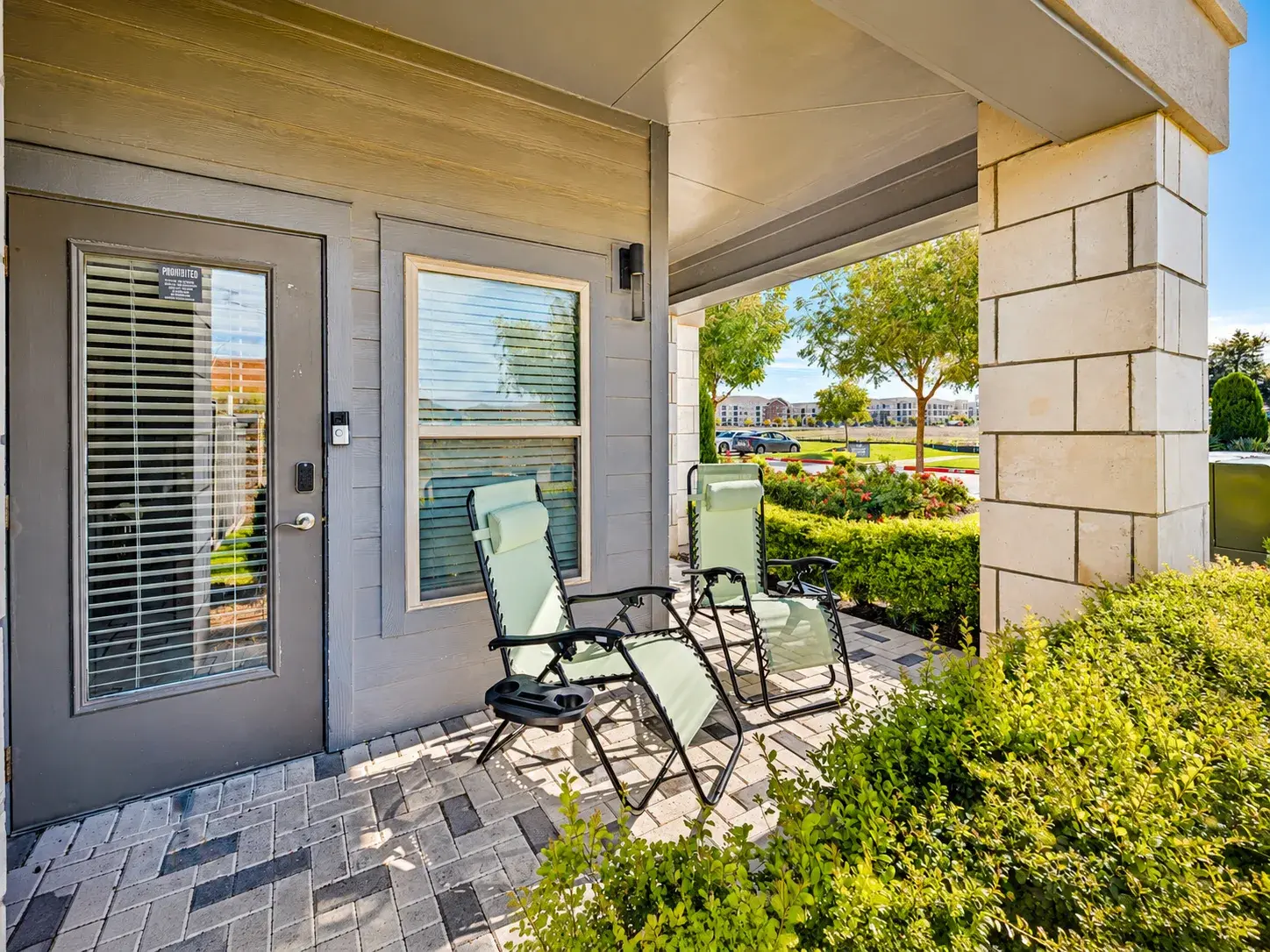Relax on the covered patio with comfy loungers and landscaped views