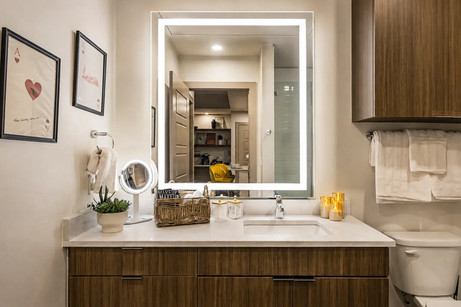 Modern bathroom with backlit mirror, sleek vanity, and spa-like touches