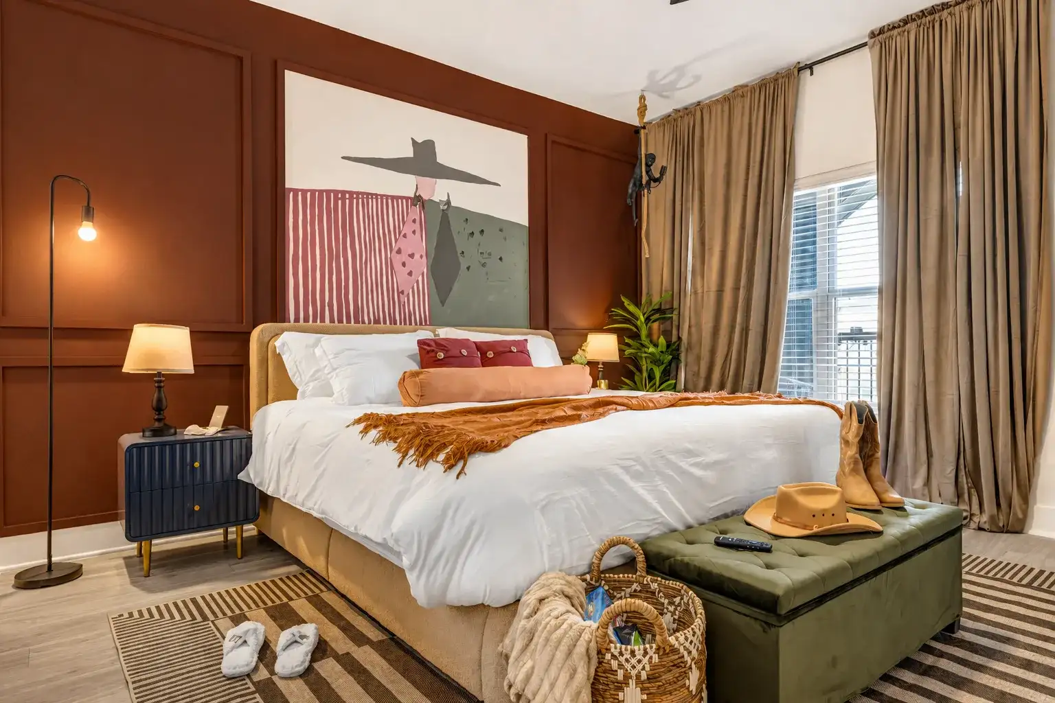 Boutique-style king bedroom with rich accents, natural light, and cozy touches