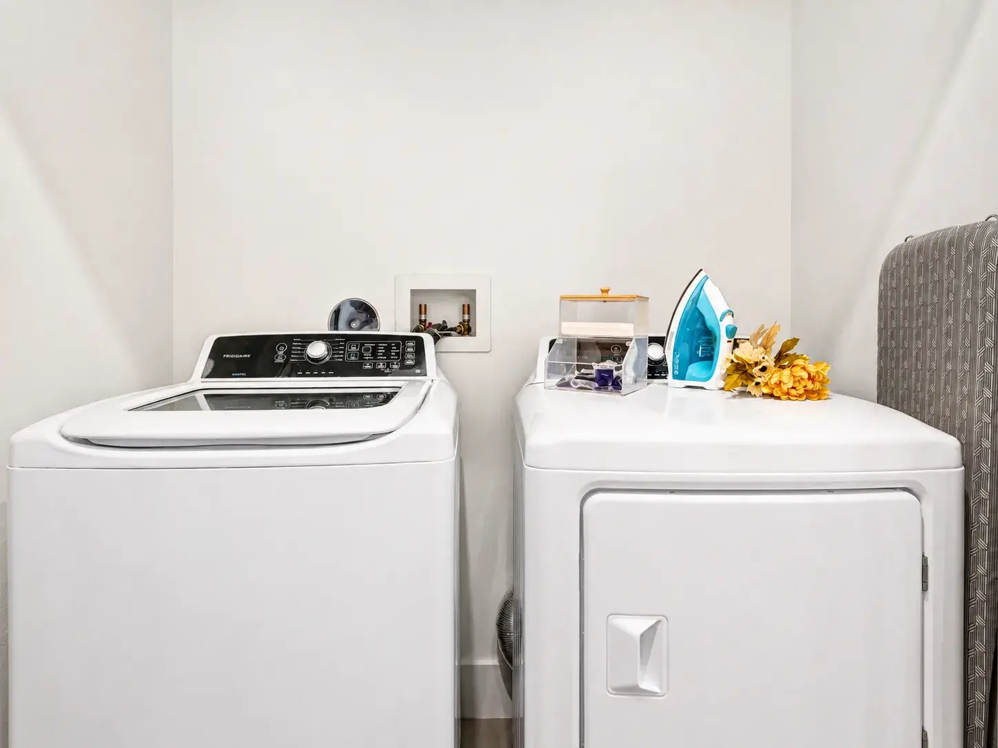 Convenient in-home laundry with full-size washer, dryer, and ironing essentials
