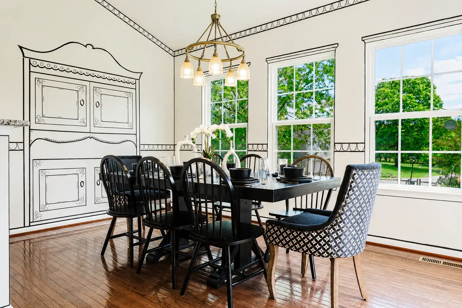Bright, elegant dining room with garden views and designer details