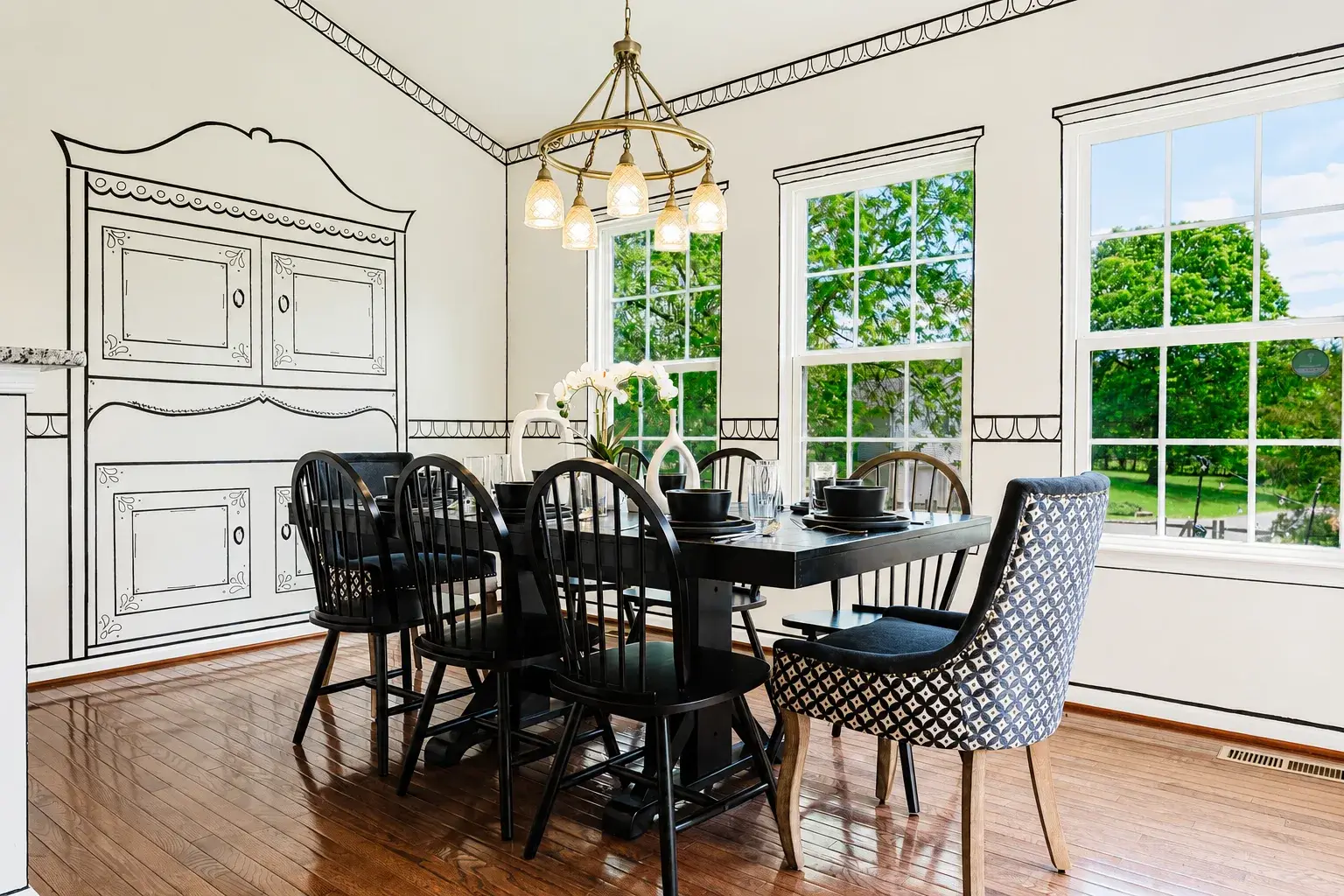 Bright, elegant dining room with garden views and designer details