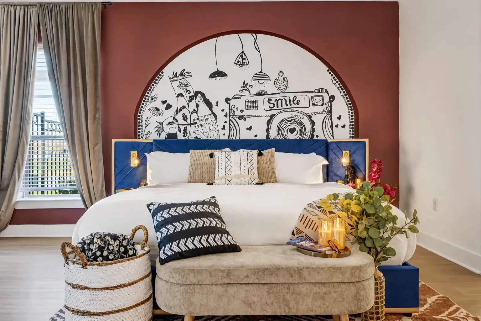 Artful king bedroom with bold mural, cozy lighting, and boutique style