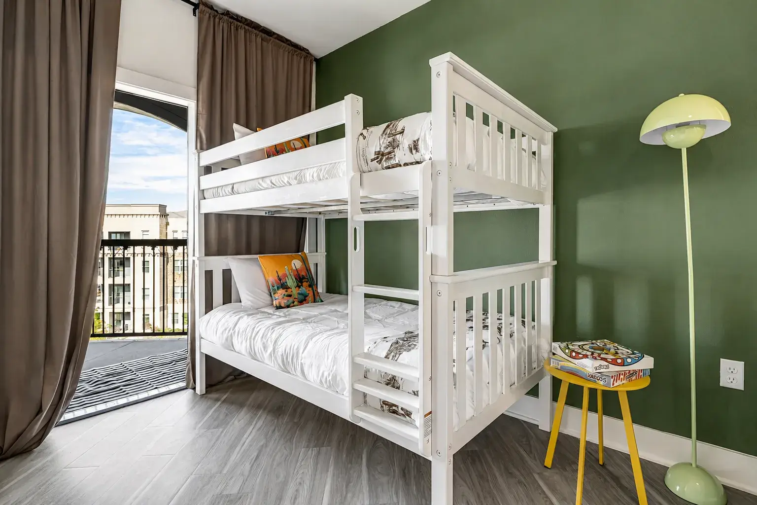 Bright bunk room with private balcony and fun modern design