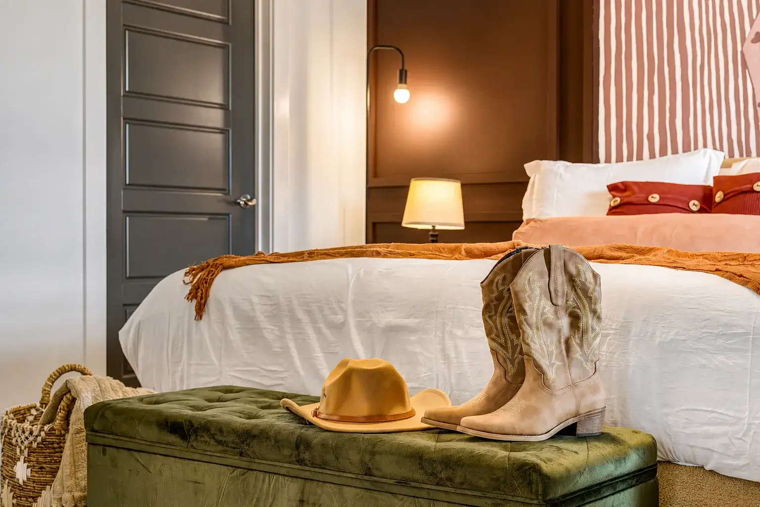 Cozy designer bedroom with warm tones, plush bed, and stylish rustic accents