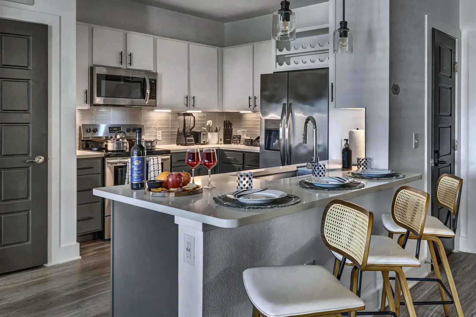 Modern kitchen with island seating, stainless appliances, and stylish finishes