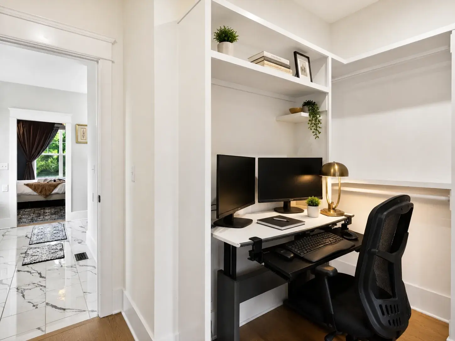 Bright built-in workspace with dual monitors and an ergonomic chair