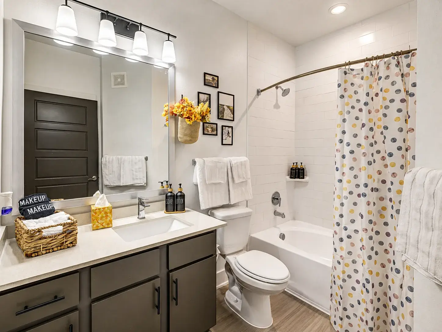 Bright modern bathroom with large vanity and tub-shower combo