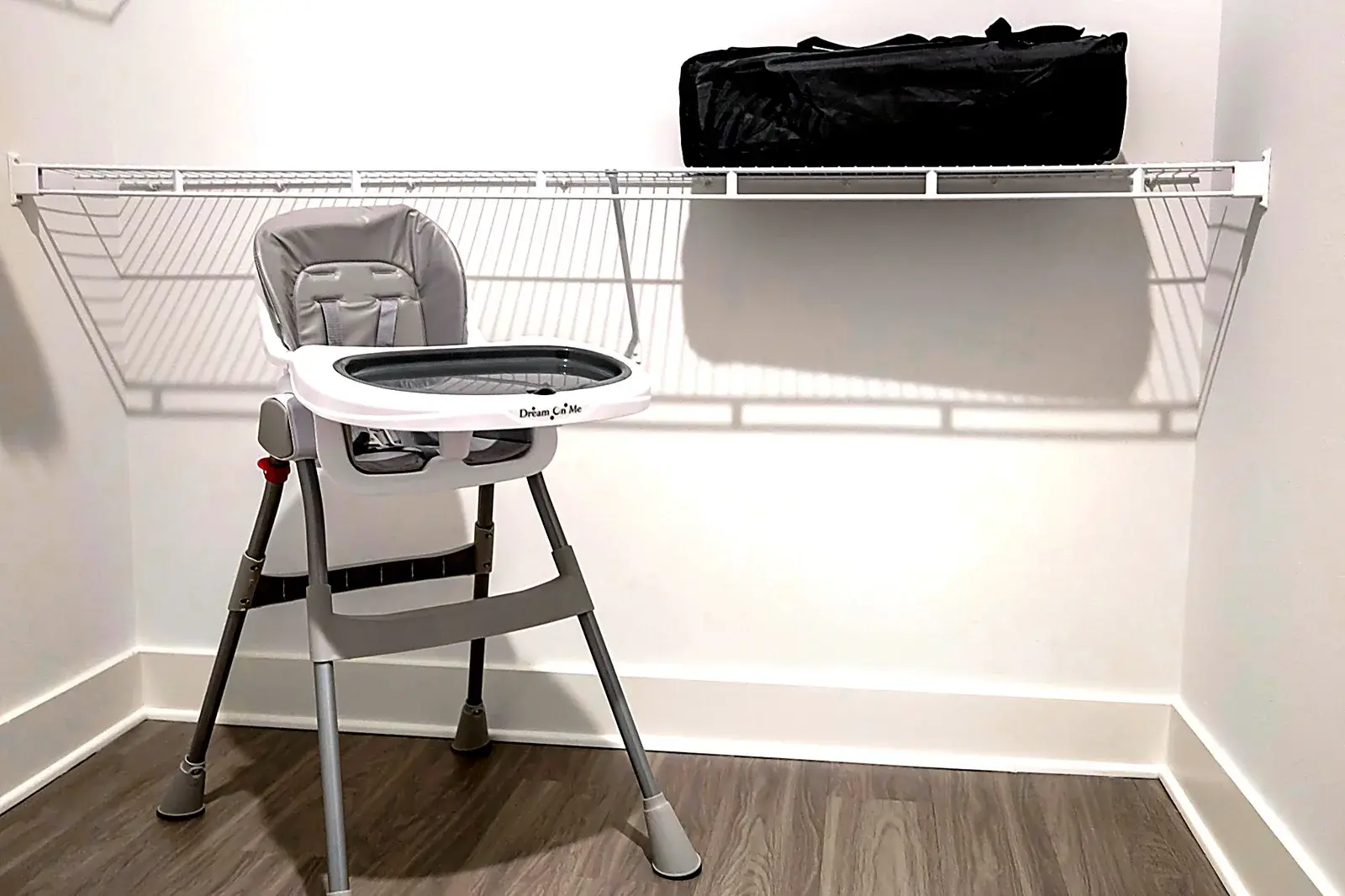 Family-ready closet with high chair and storage shelf, modern convenience