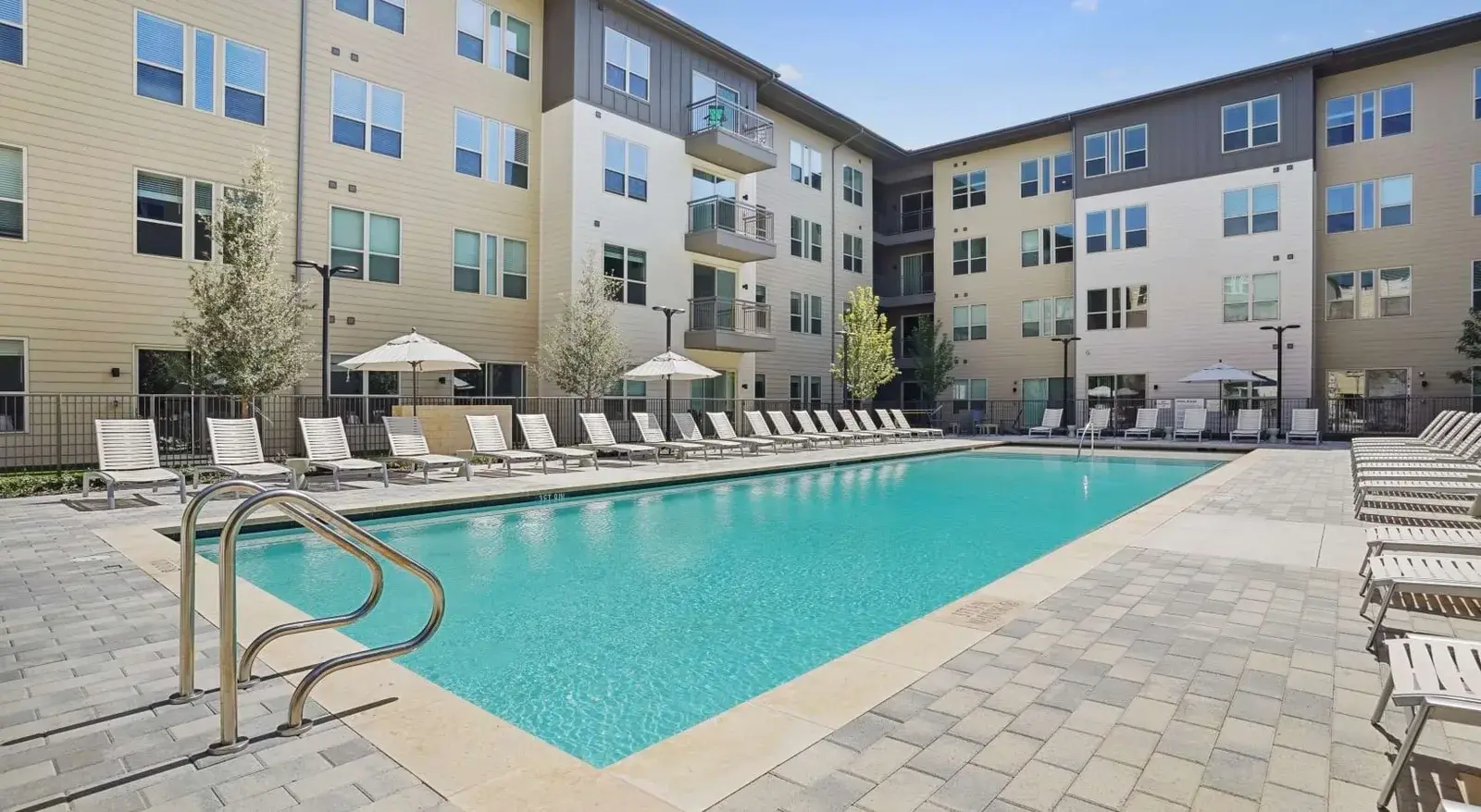 Community pool courtyard with loungers
