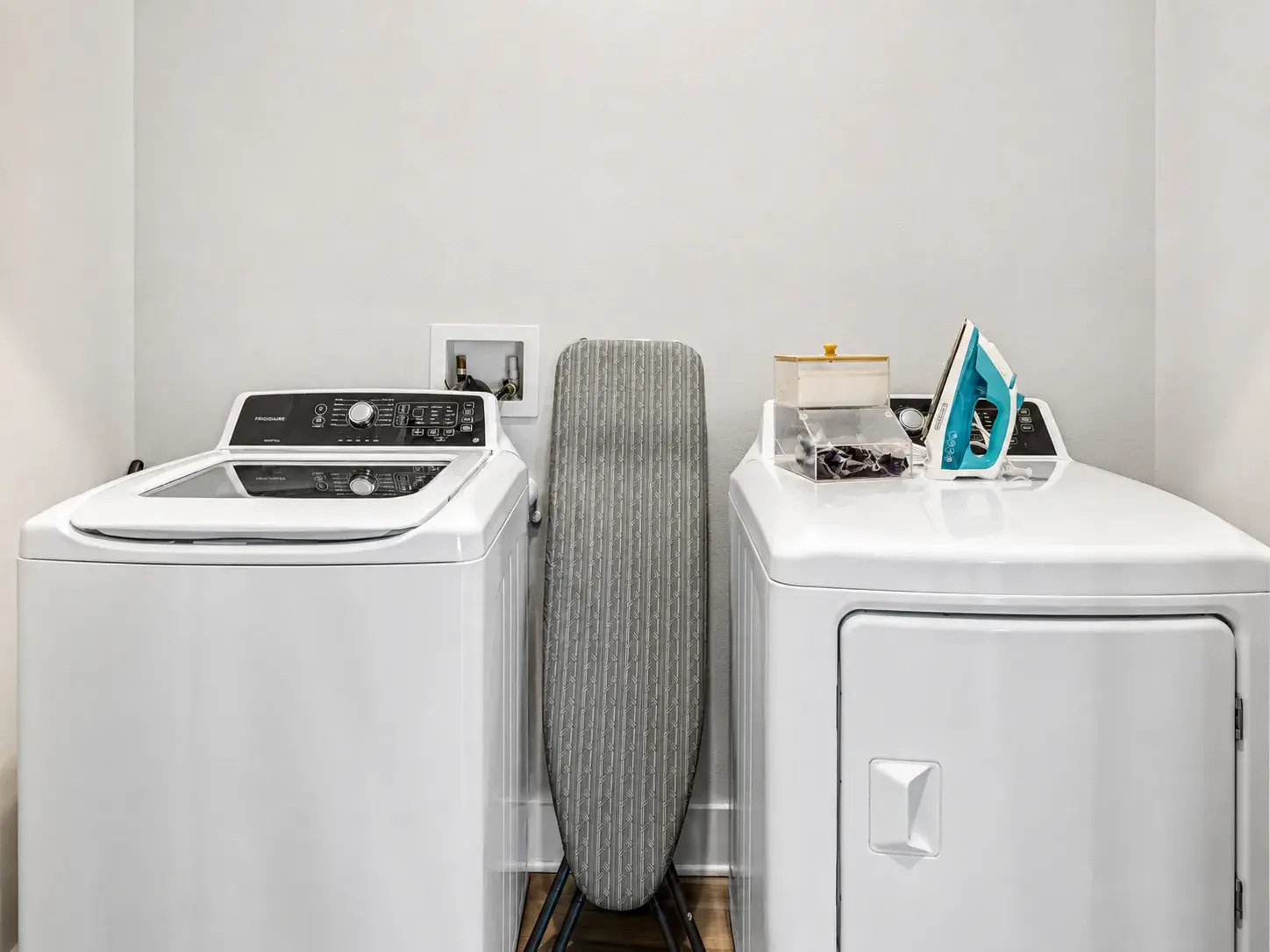 Convenient in-home laundry with washer, dryer, iron, and ironing board