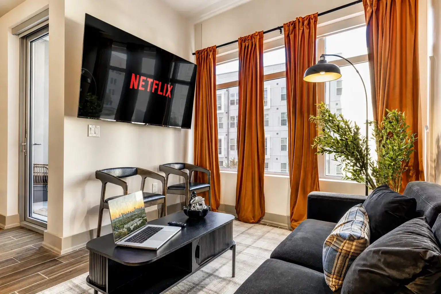 Bright modern lounge with big windows, Netflix, and a cozy sectional