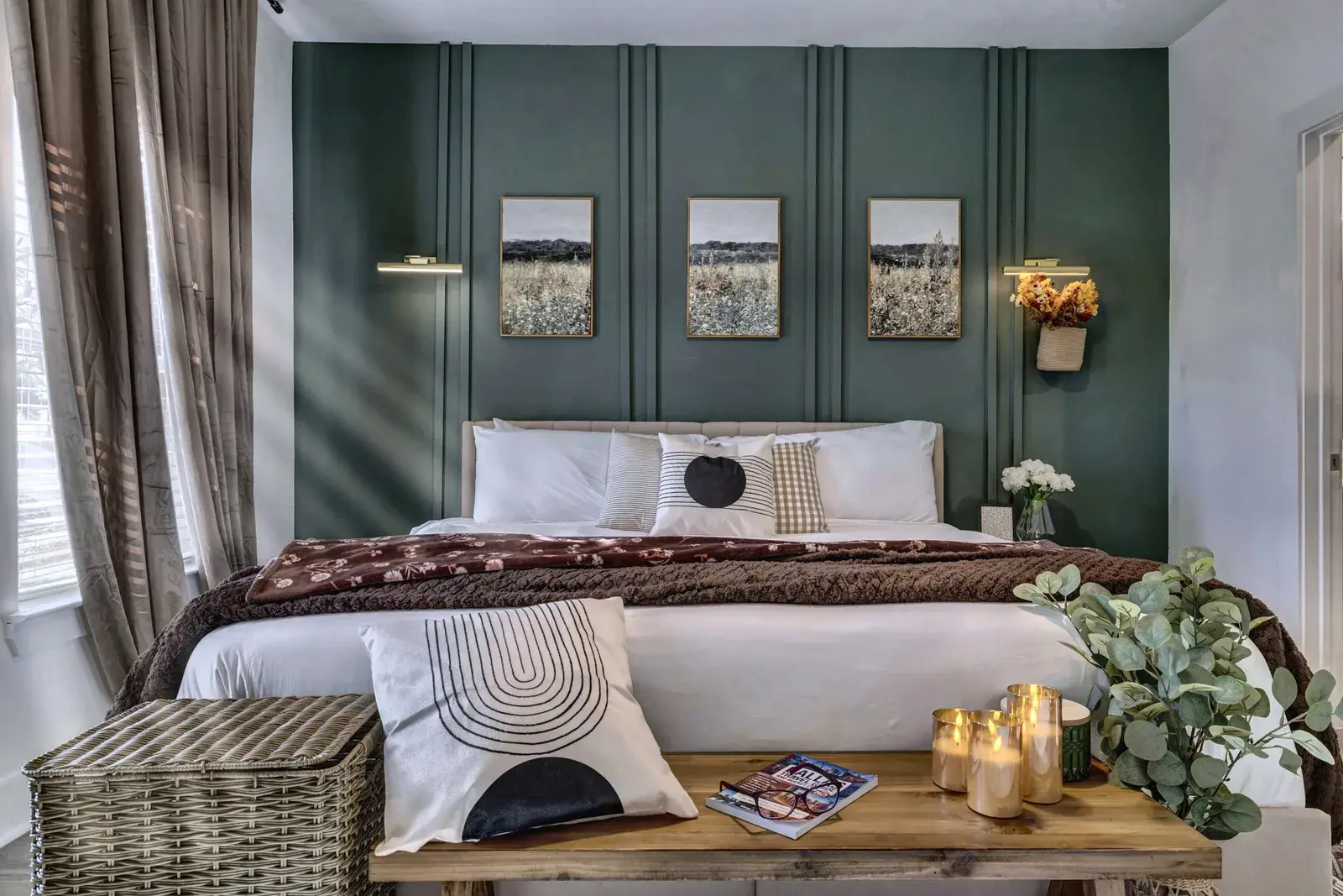 Elegant bedroom with cozy king bed and rich green accent wall