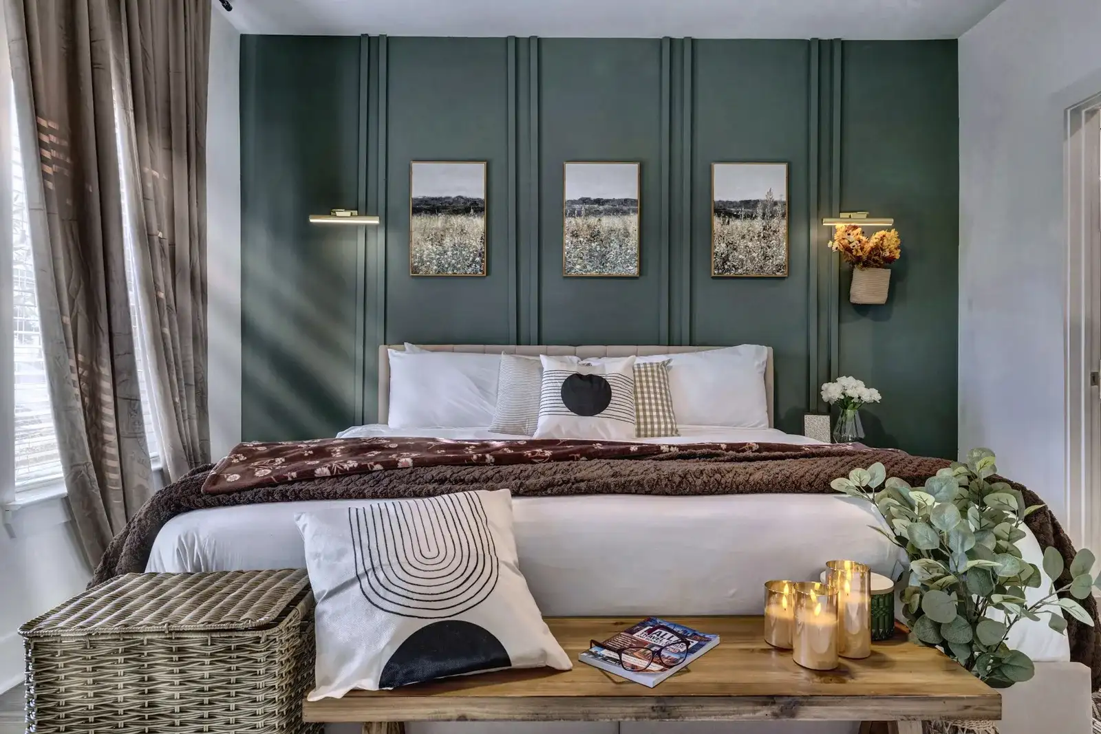 Elegant bedroom with cozy king bed and rich green accent wall