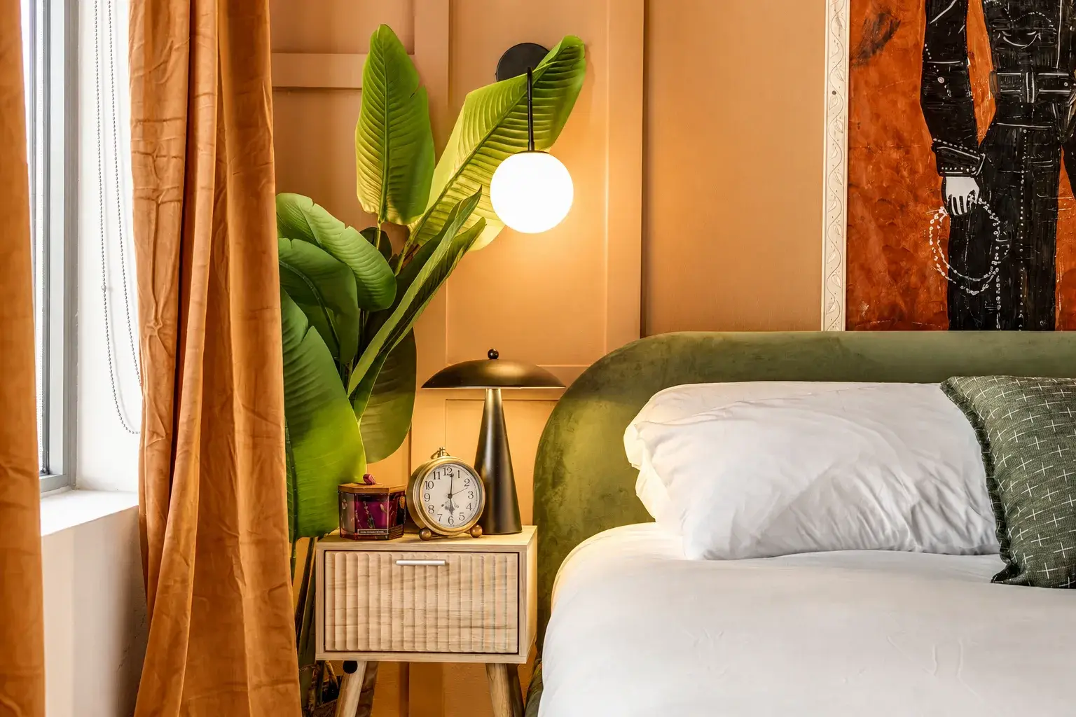 Elegant bedroom with warm lighting, plush accents, and boutique-style charm
