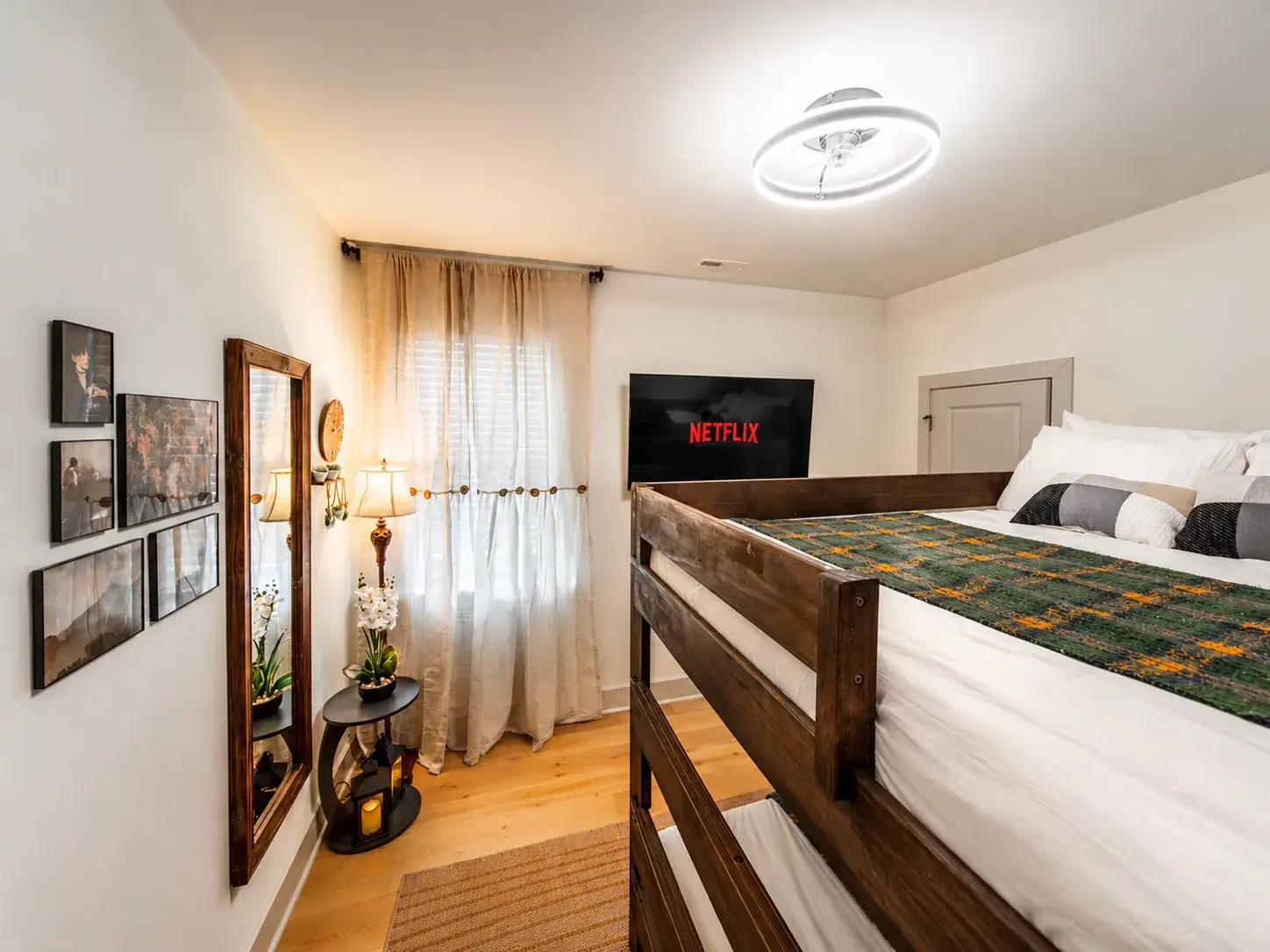 Cozy bunk room with TV, warm lighting, and stylish rustic touches