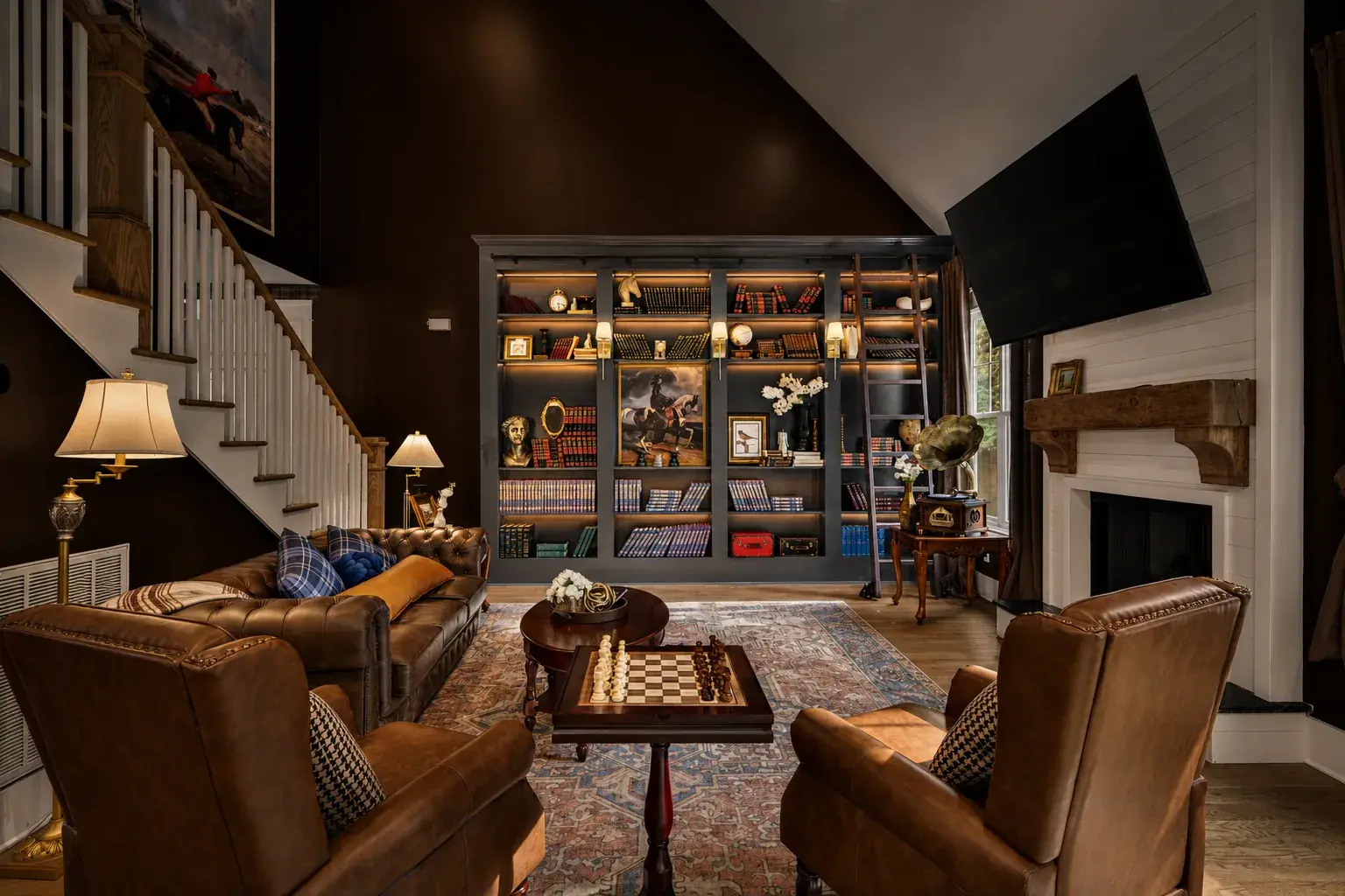 Sophisticated lounge with leather seating, fireplace, and stunning library wall