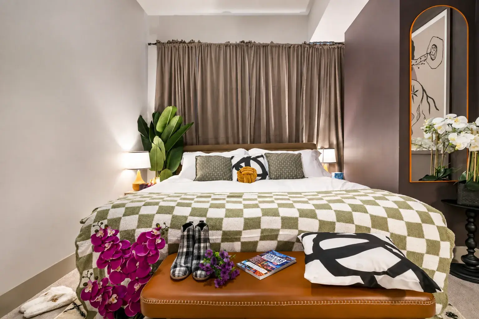 Cozy designer bedroom with king bed, soft lighting, and stylish accents