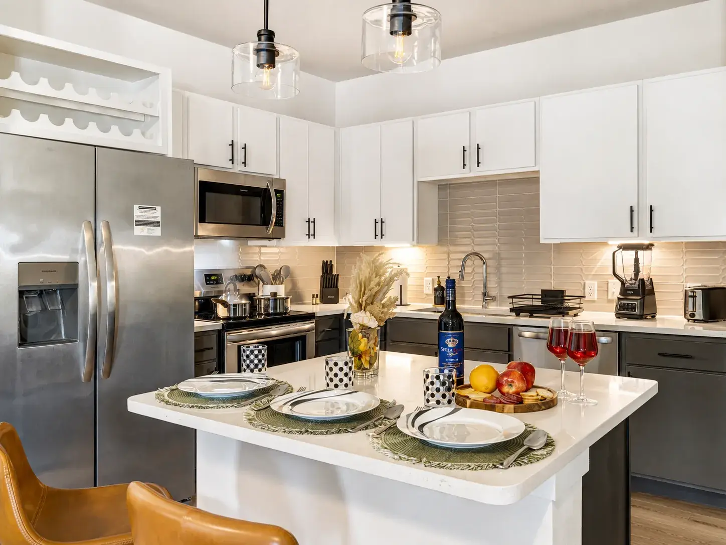 Bright modern kitchen with island dining and stainless steel appliances
