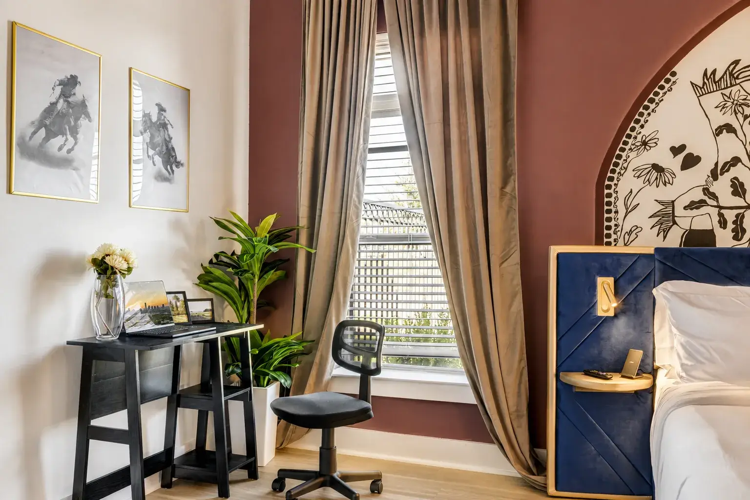 Chic bedroom with workspace, statement wall, and elegant natural light
