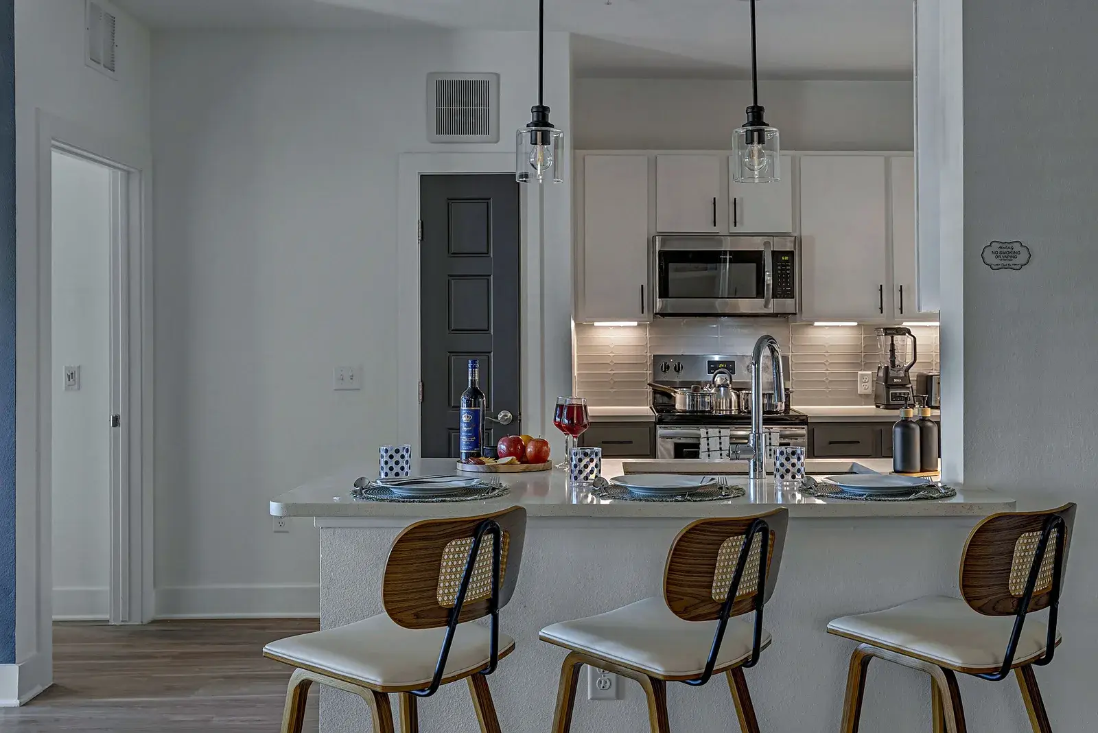 Modern kitchen with breakfast bar seating for 3 and sleek finishes