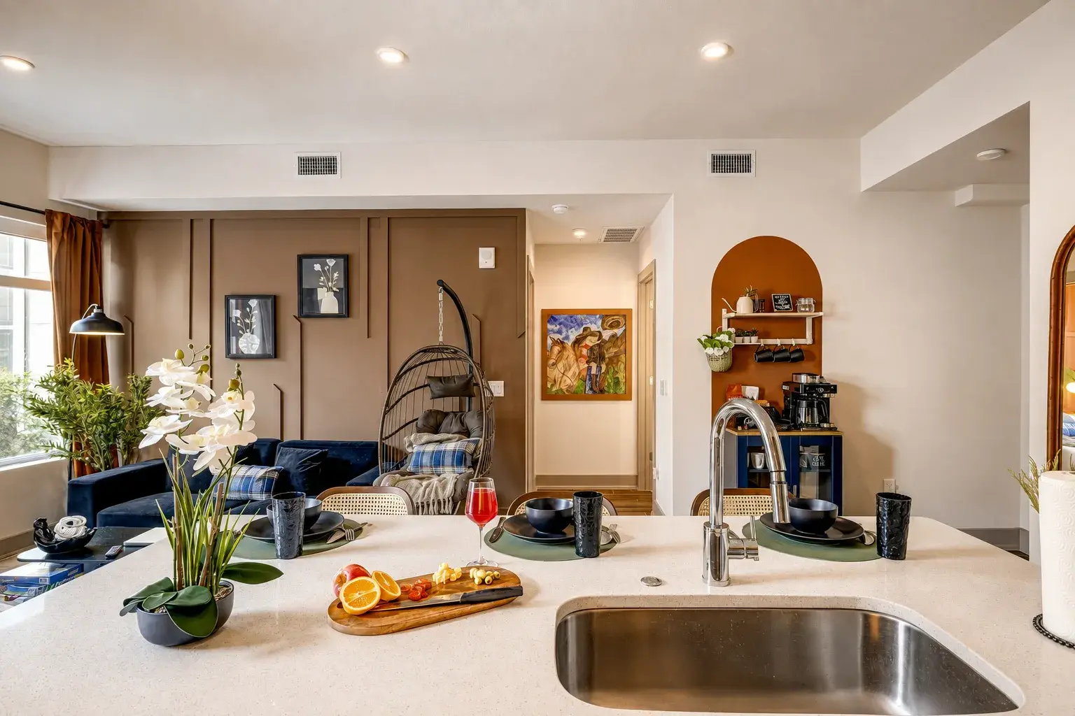 Bright open-concept kitchen and lounge with stylish decor & coffee bar