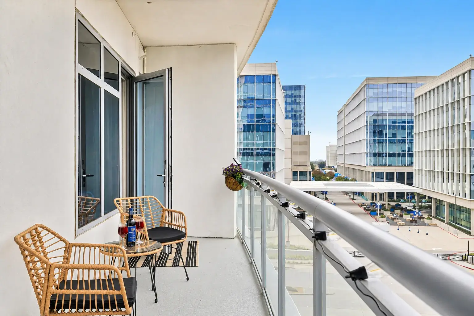 Private city-view balcony with cozy seating for morning coffee or evening drinks