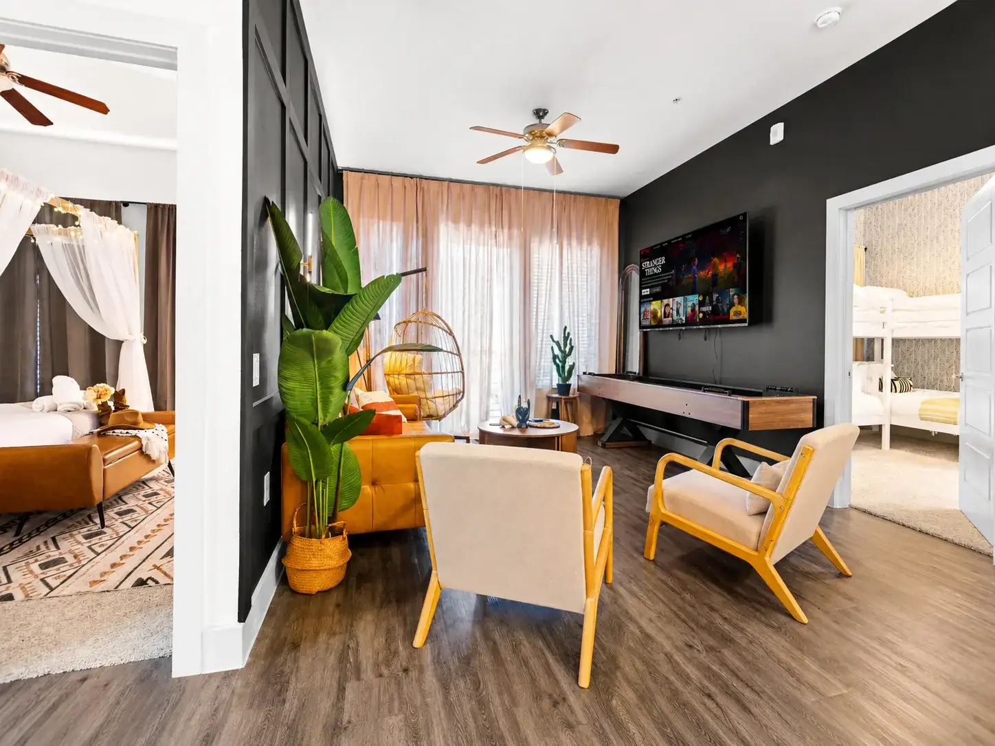 Stylish lounge with bold accent walls, TV, and bright open-concept design