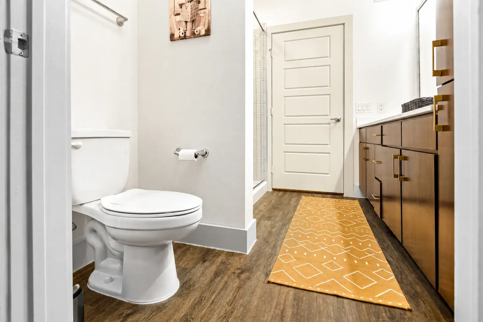 Bright modern bathroom with stylish vanity and warm designer touches