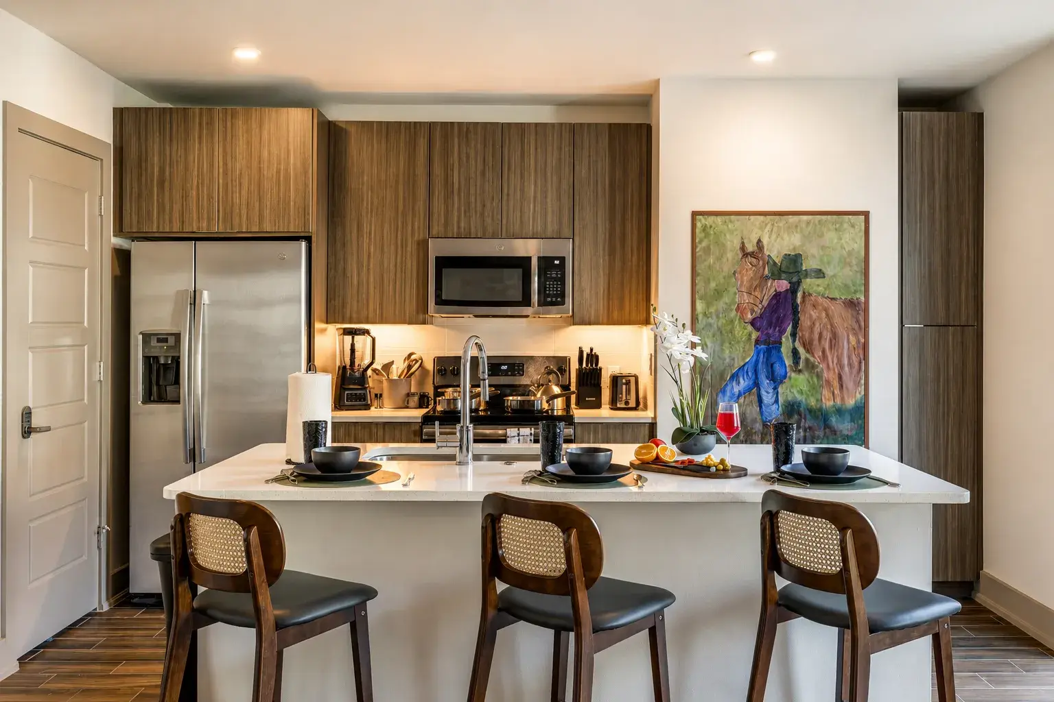 Modern chef’s kitchen with island seating and warm designer finishes