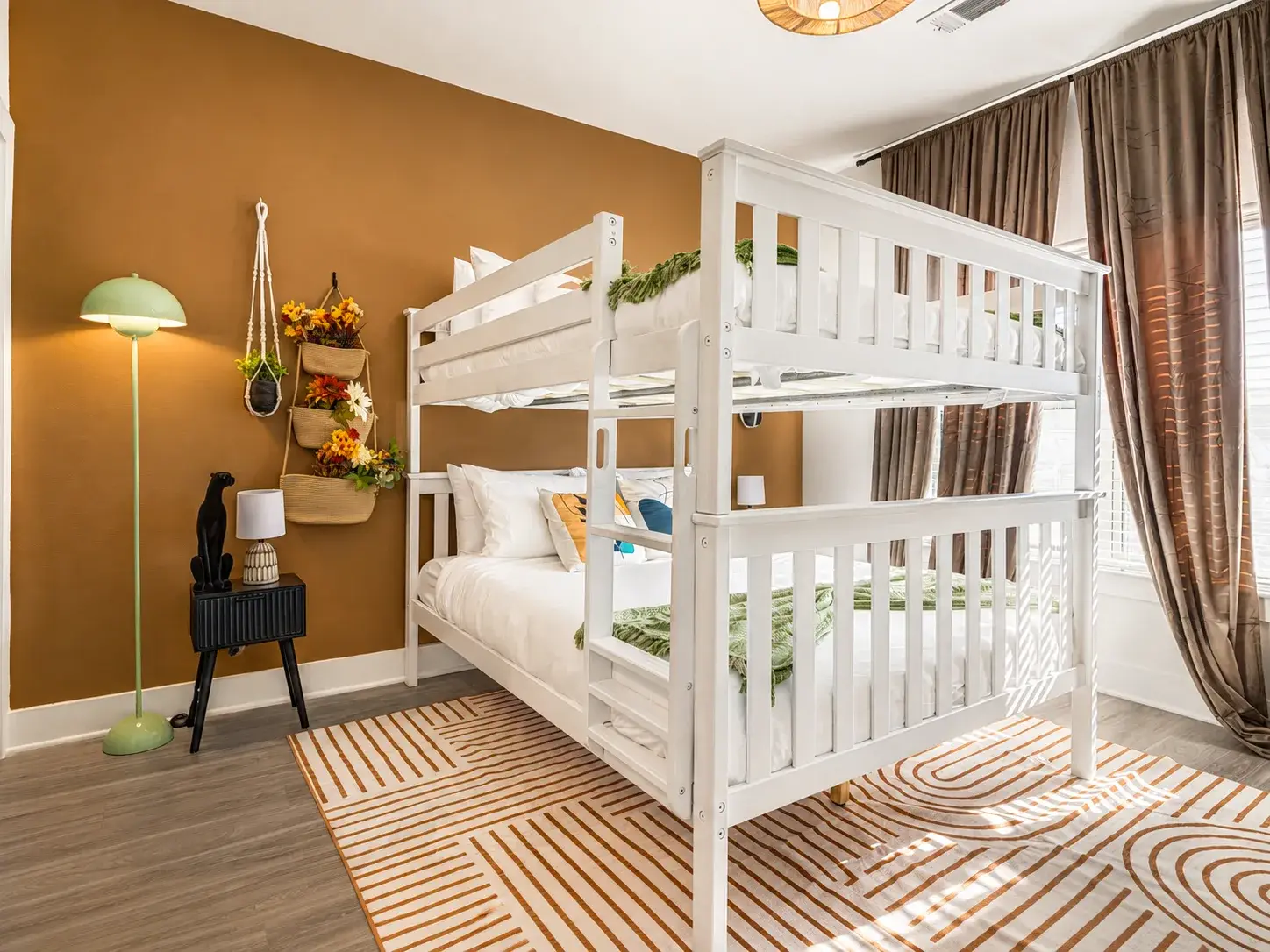 Bright, cozy bunk room with stylish decor and plenty of natural light
