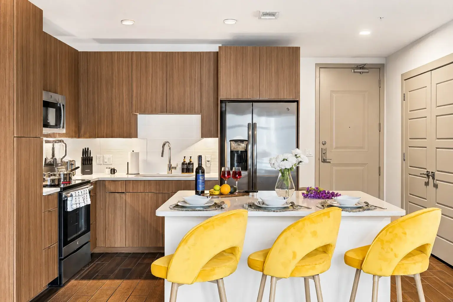 Modern kitchen with island seating, stainless appliances, and chic decor