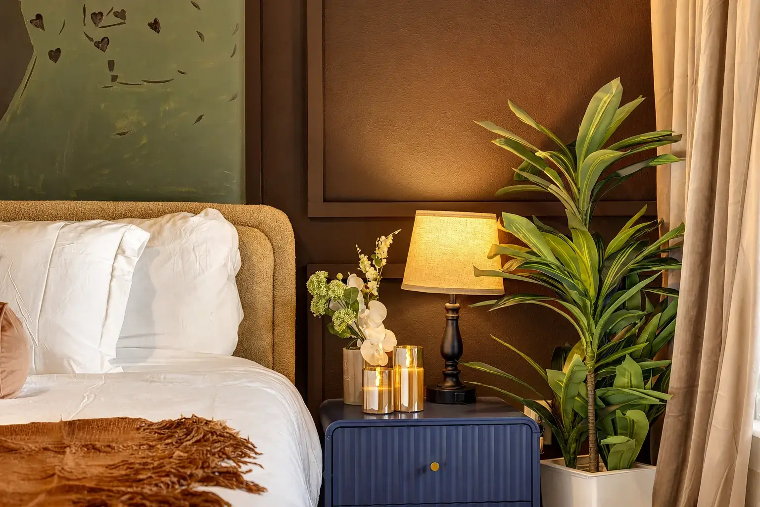 Warm, elegant bedroom corner with plush linens and soothing ambient lighting