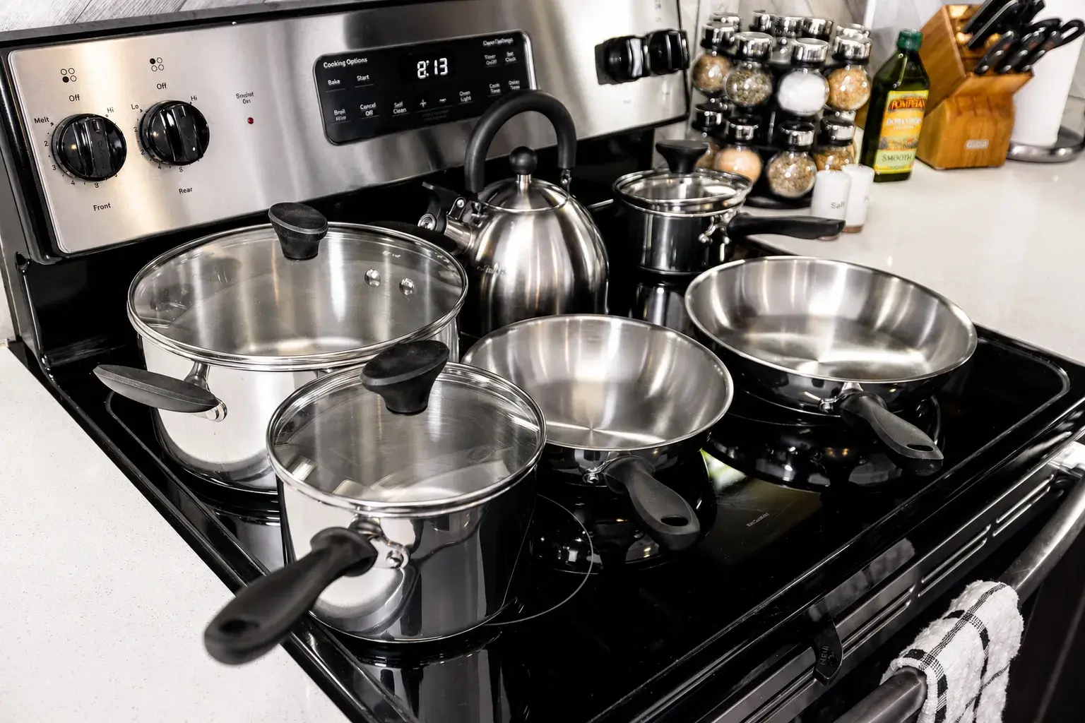 Fully equipped kitchen with cookware, spices, and modern stainless range