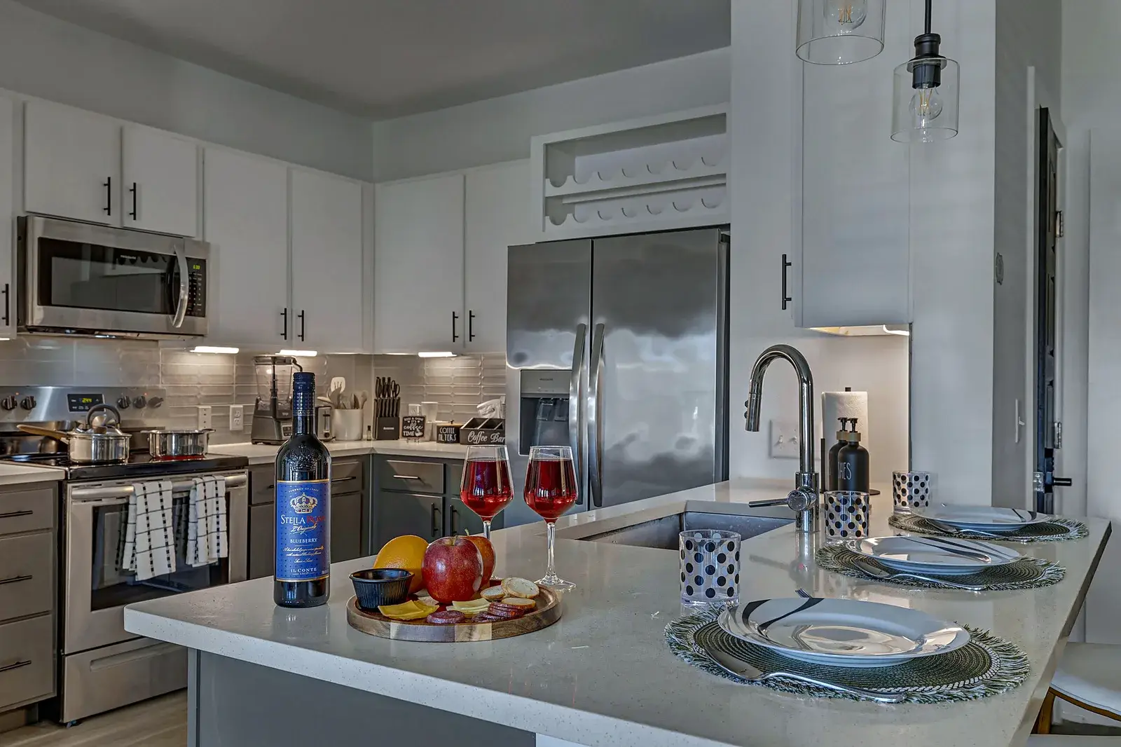 Modern kitchen with island seating, stainless appliances, and dining setup
