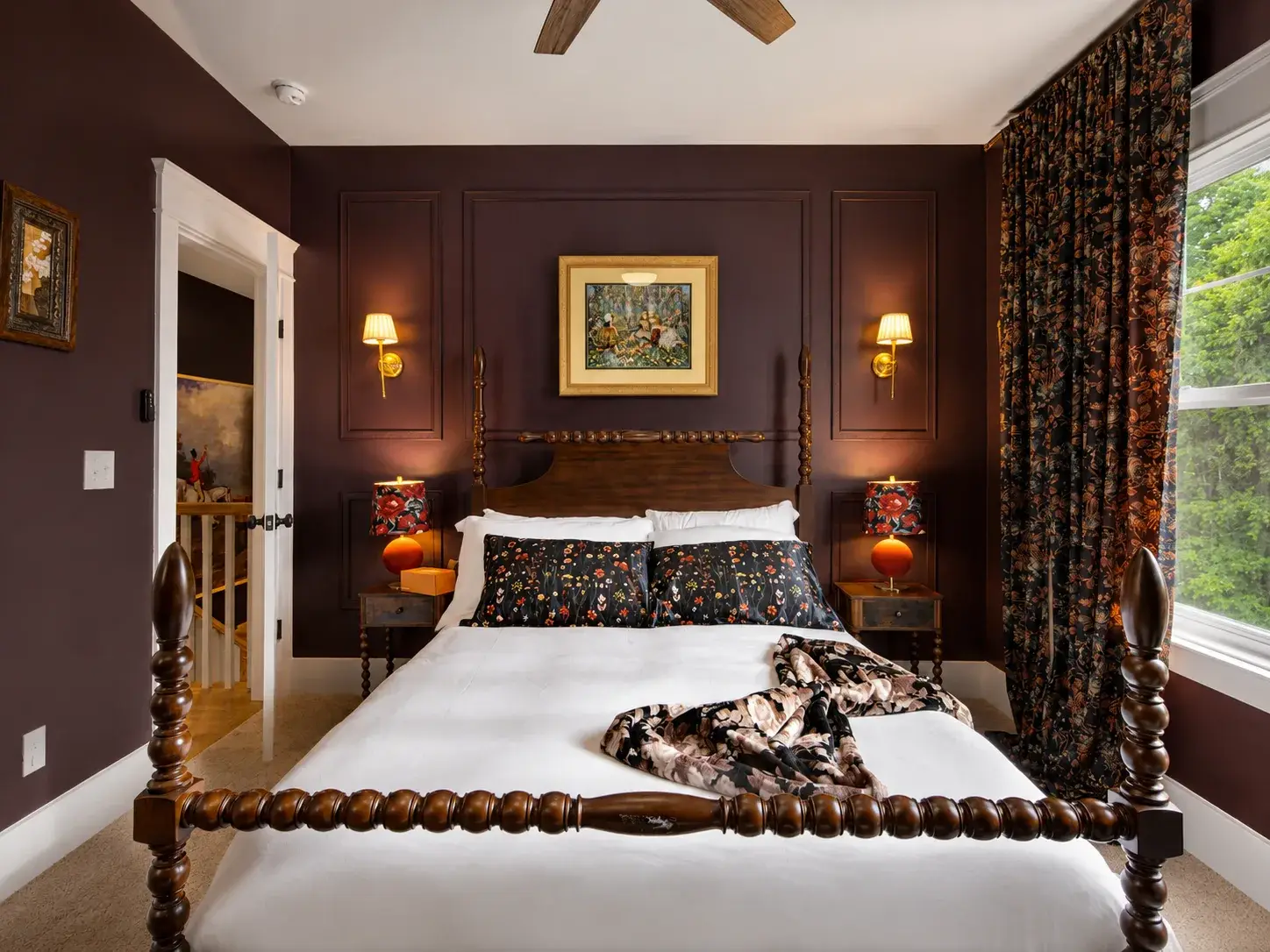 Elegant four-poster bedroom with rich tones and boutique-style charm