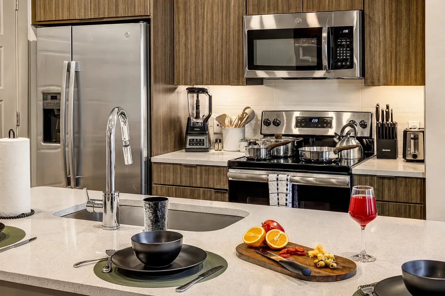 Modern gourmet kitchen with island seating and stainless steel appliances