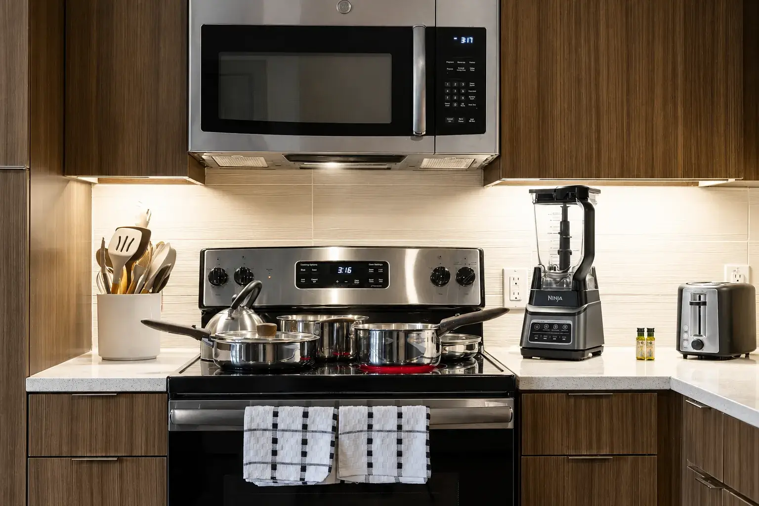 Modern, fully equipped kitchen with sleek finishes and warm lighting
