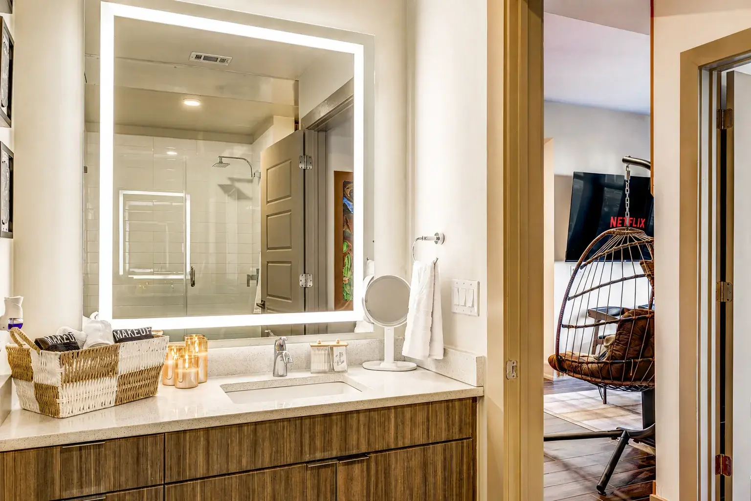 Modern spa-like vanity with LED mirror and thoughtful guest amenities