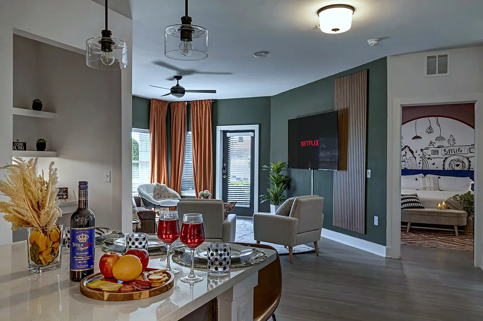 Stylish open living space with TV, natural light, and a welcoming kitchen island