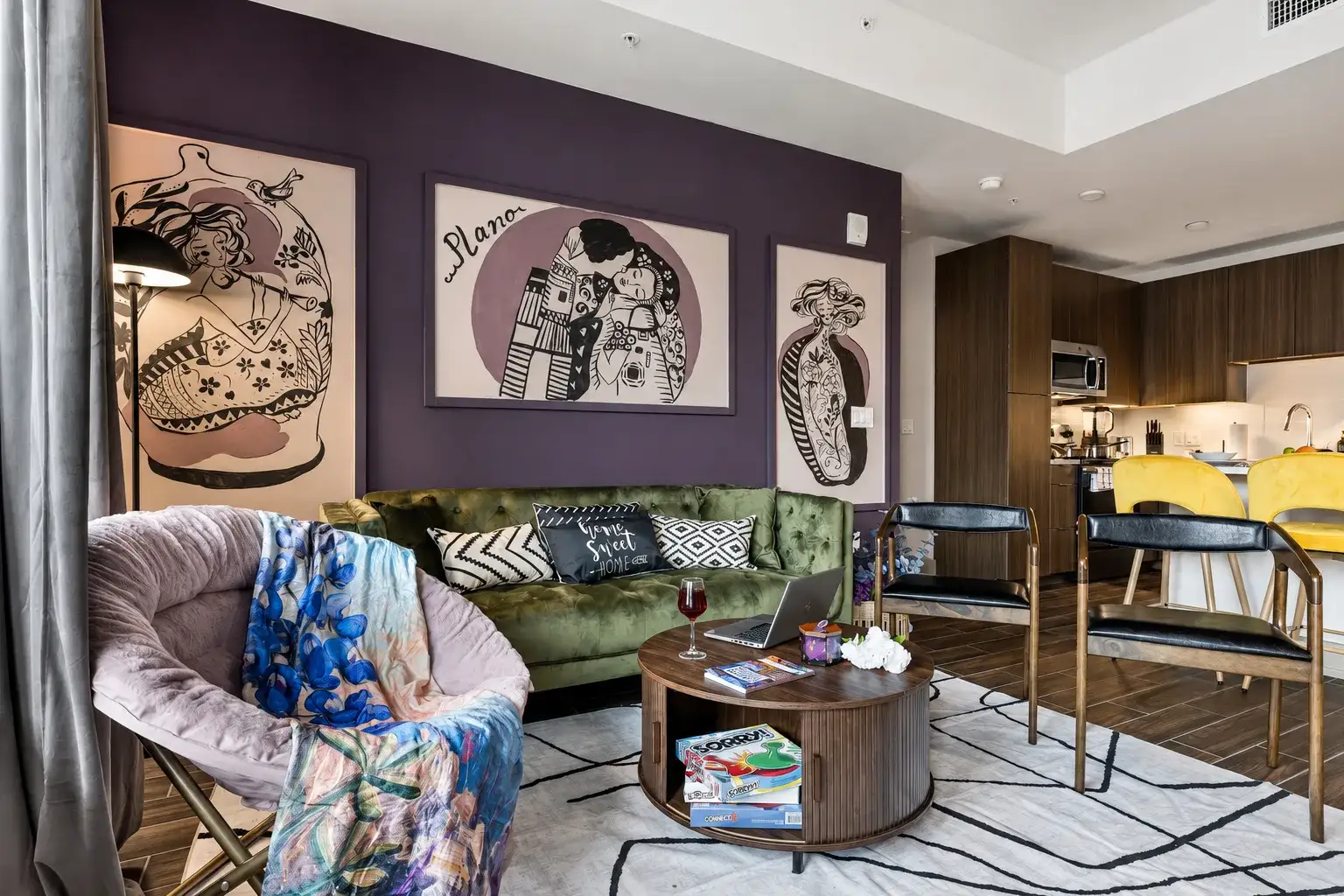 The velvet lounge, with a green velvet sofa, art wall and smart TV for winding down